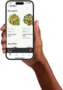 Hand holding a phone with the Farmer's Fridge App